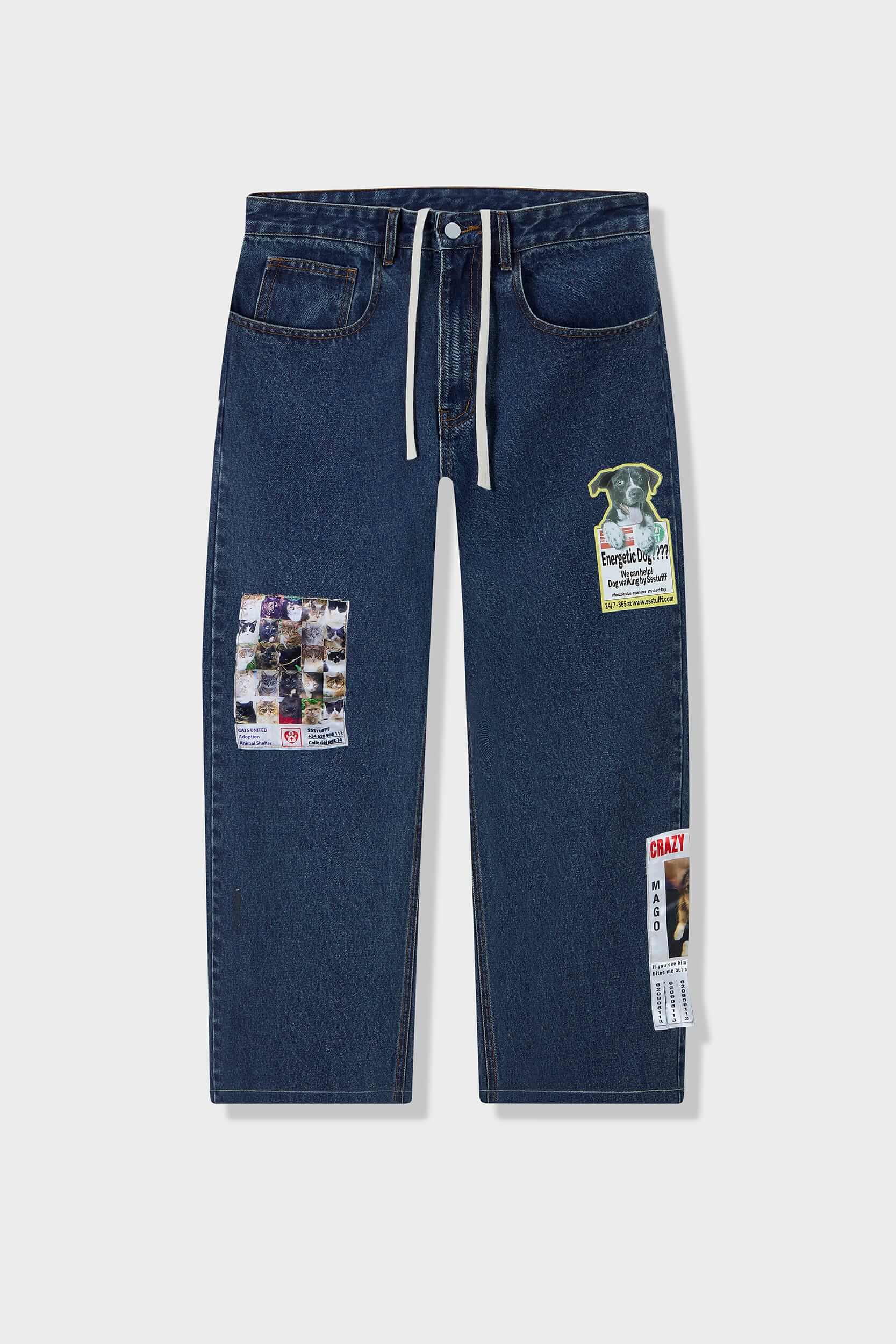 Medium blue relaxed fit jeans with embroidered and printed patches and white lace waist tie