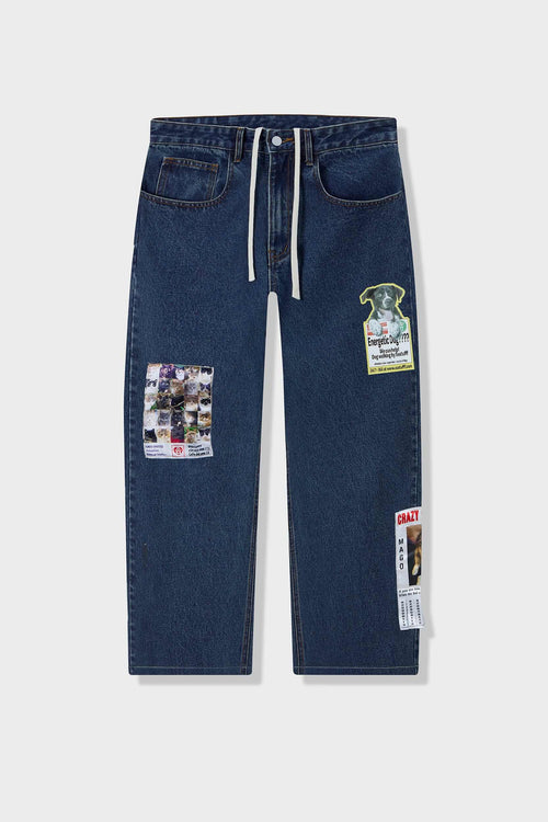 Medium blue relaxed fit jeans with embroidered and printed patches and white lace waist tie