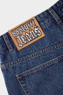 Medium blue relaxed fit jeans with embroidered and printed patches and white lace waist tie