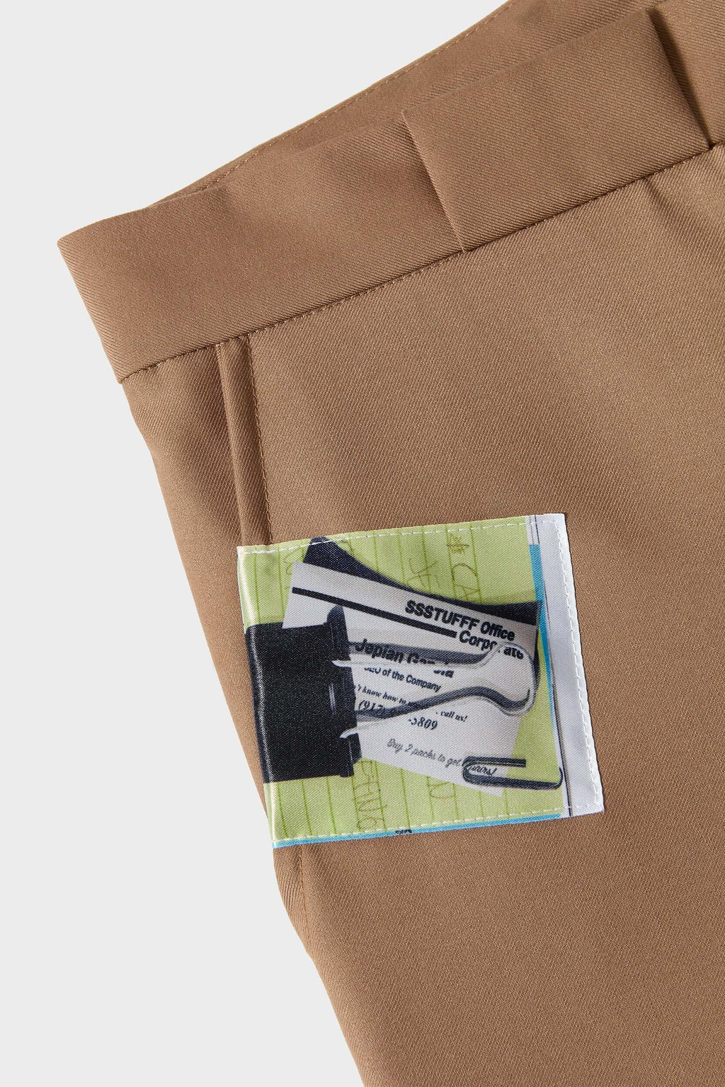 Beige cotton twill trousers with tailored straight fit and SSSTUFFF button detailing on legs