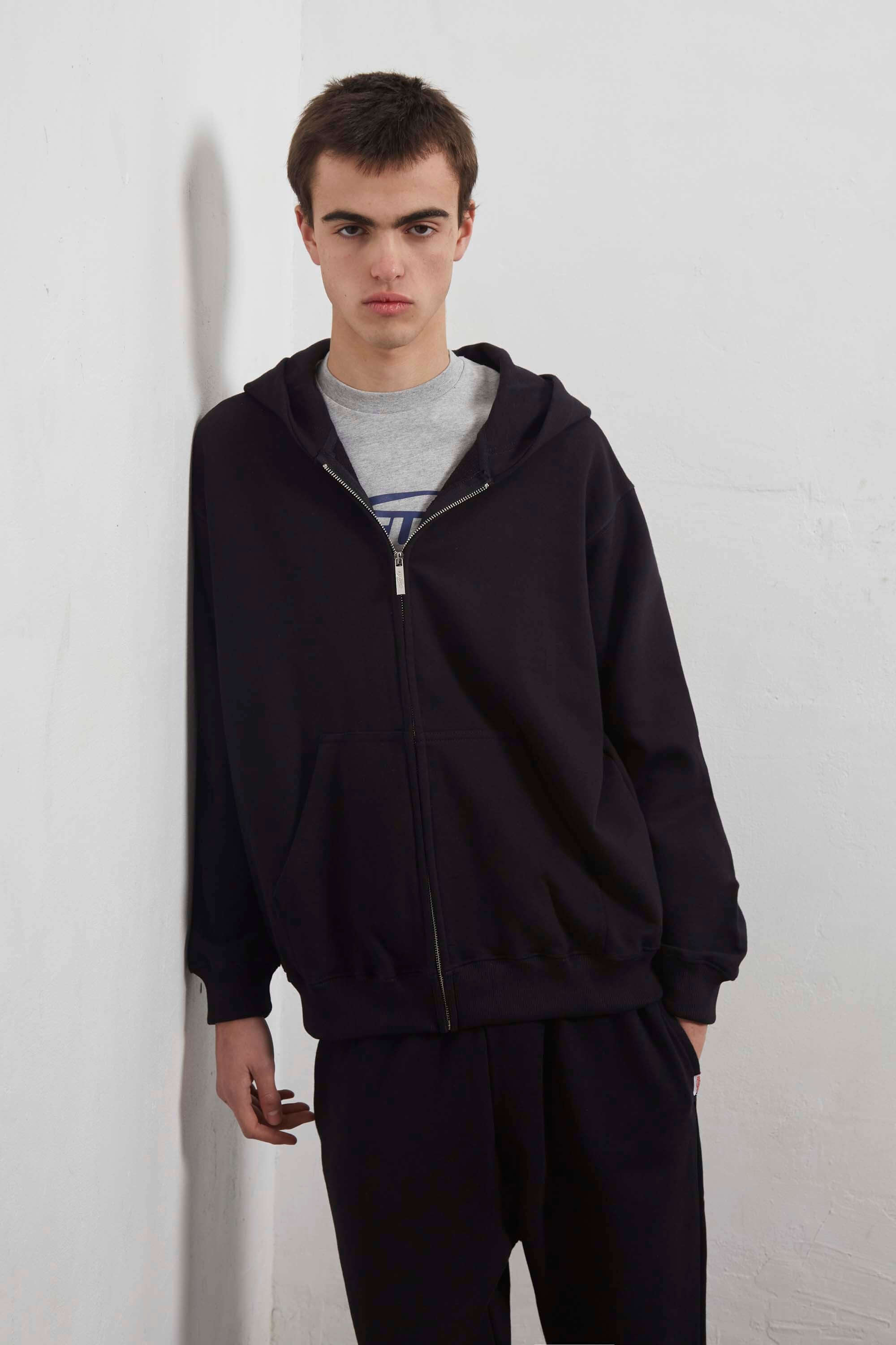 Black zip-up hoodie with embroidered mini logo on the back
