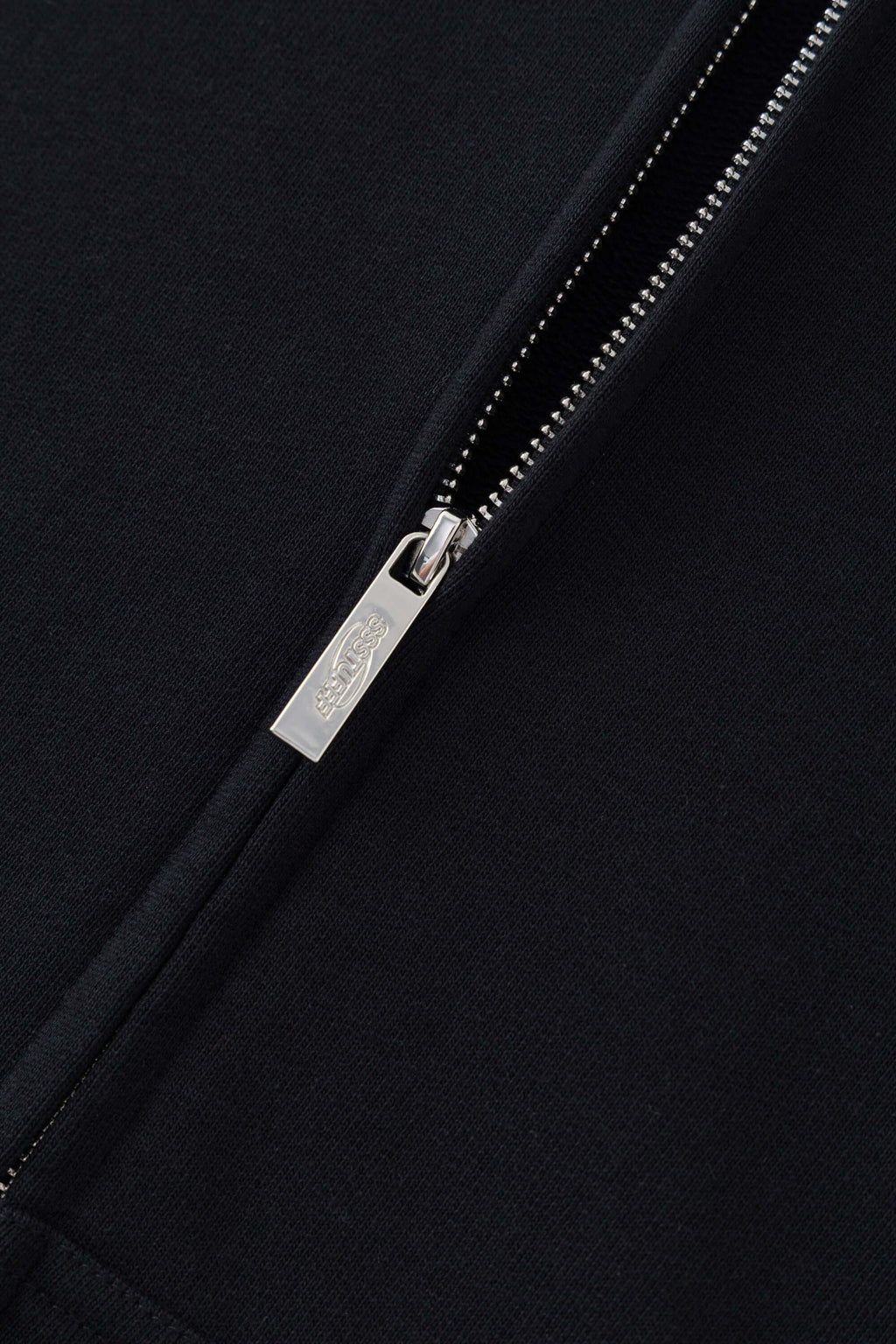 Black zip-up hoodie with embroidered mini logo on the back