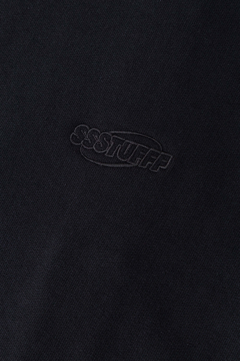 Black zip-up hoodie with embroidered mini logo on the back