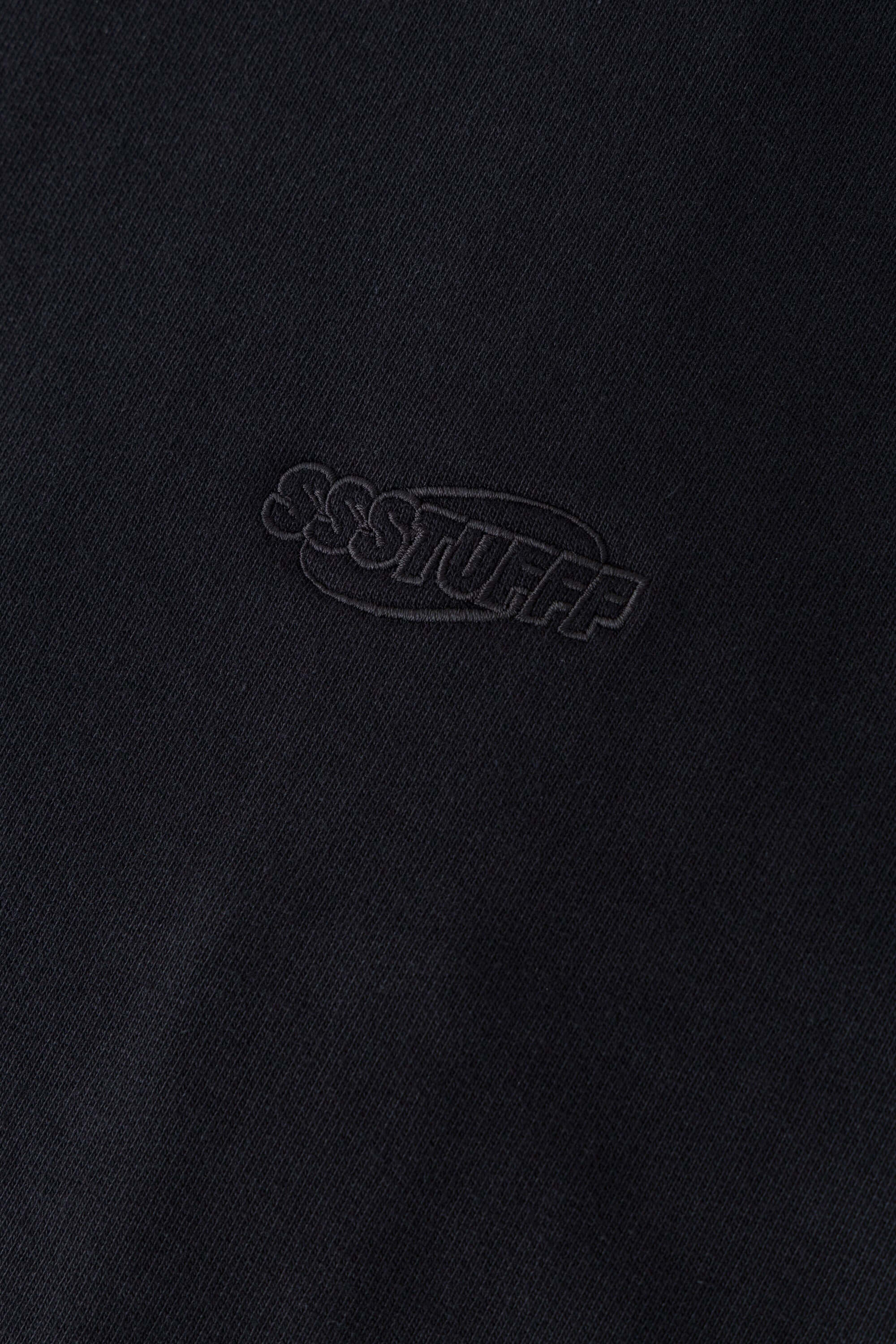 Black zip-up hoodie with embroidered mini logo on the back