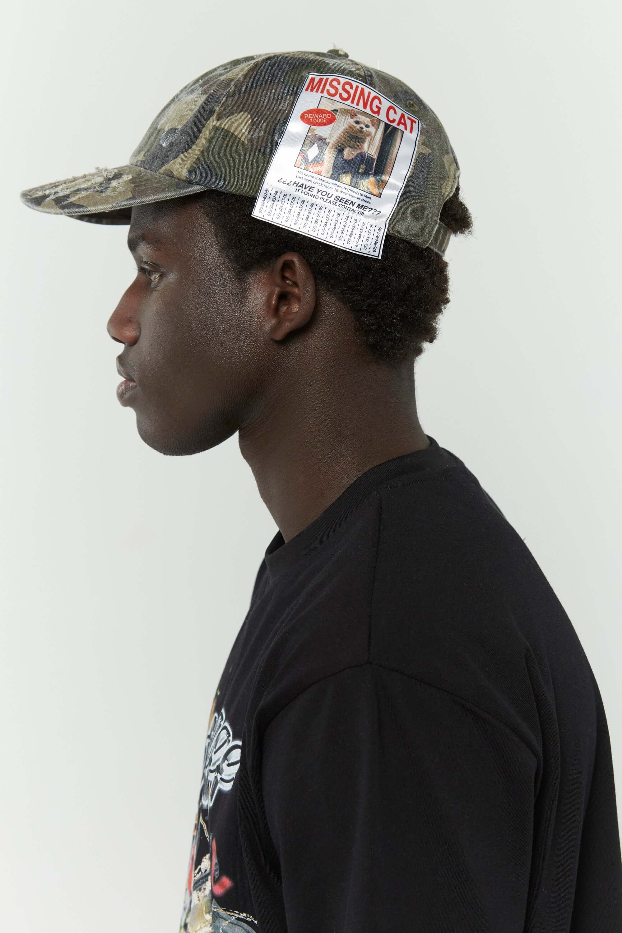 Camo cotton cap with missing cat jacquard patch and handcrafted cat scratches and footprints