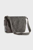 Messenger bag with UV printed charm graphics, adjustable strap, and keychain details