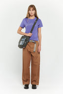 Messenger bag with UV printed charm graphics, adjustable strap, and keychain details