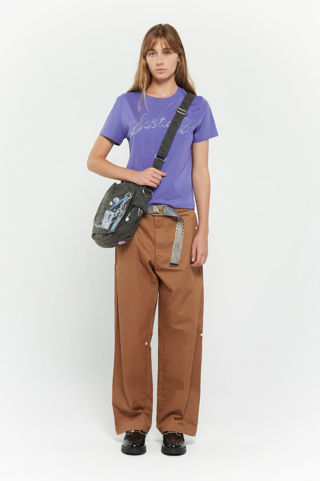 Messenger bag with UV printed charm graphics, adjustable strap, and keychain details