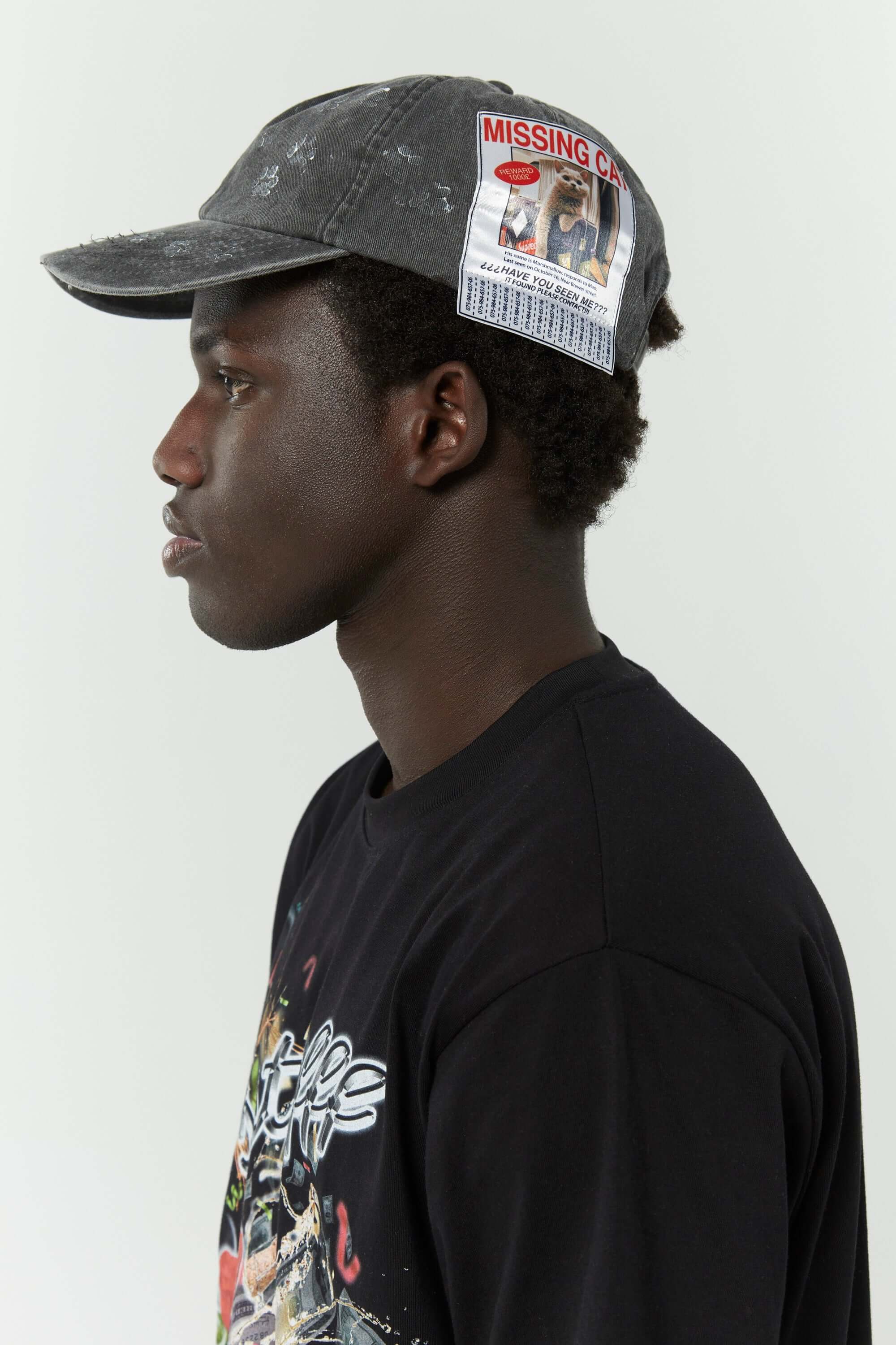 Dark grey cotton cap with missing cat jacquard patch and handcrafted cat scratches and footprints