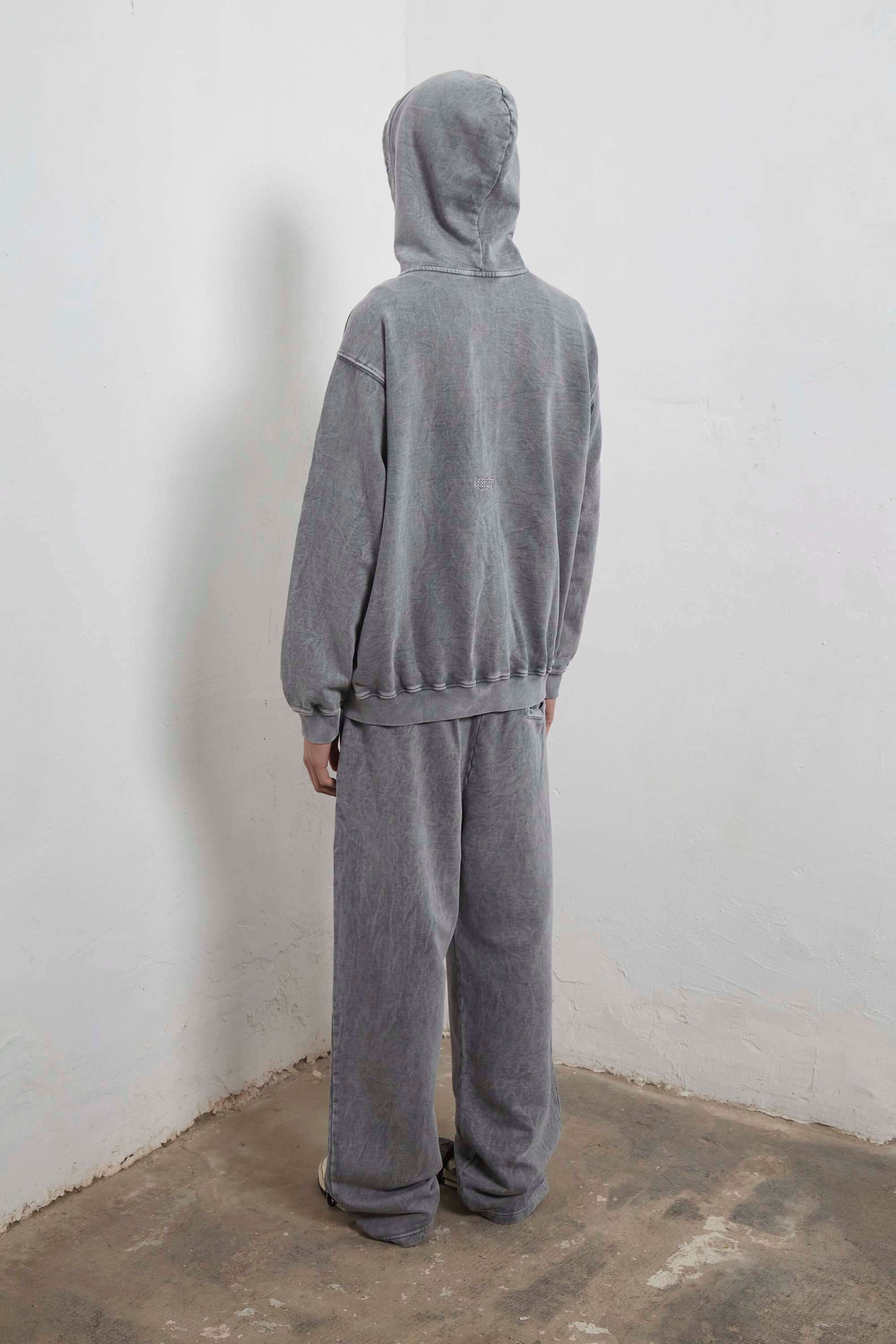 Grey zip-up hoodie with embroidered mini logo on the back