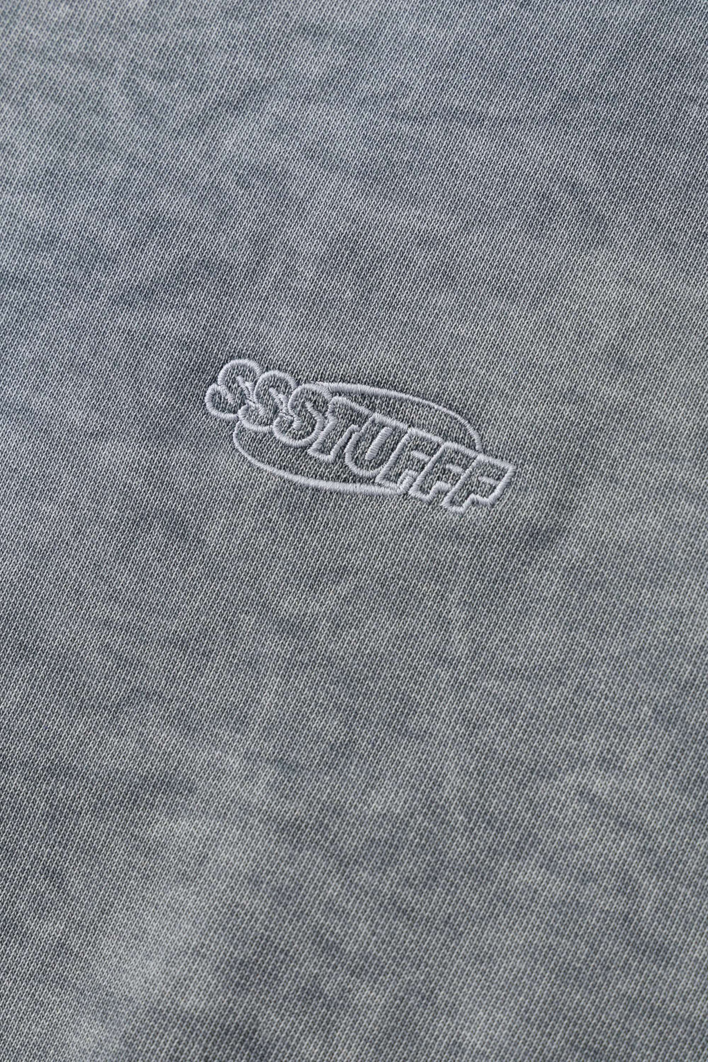 Grey zip-up hoodie with embroidered mini logo on the back
