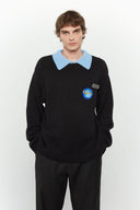 Black knit sweater designed to look like a shirt, with blue collar and attachable name tag and employee of the month pin