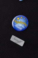 Black knit sweater designed to look like a shirt, with blue collar and attachable name tag and employee of the month pin