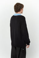 Black knit sweater designed to look like a shirt, with blue collar and attachable name tag and employee of the month pin