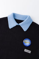 Black knit sweater designed to look like a shirt, with blue collar and attachable name tag and employee of the month pin