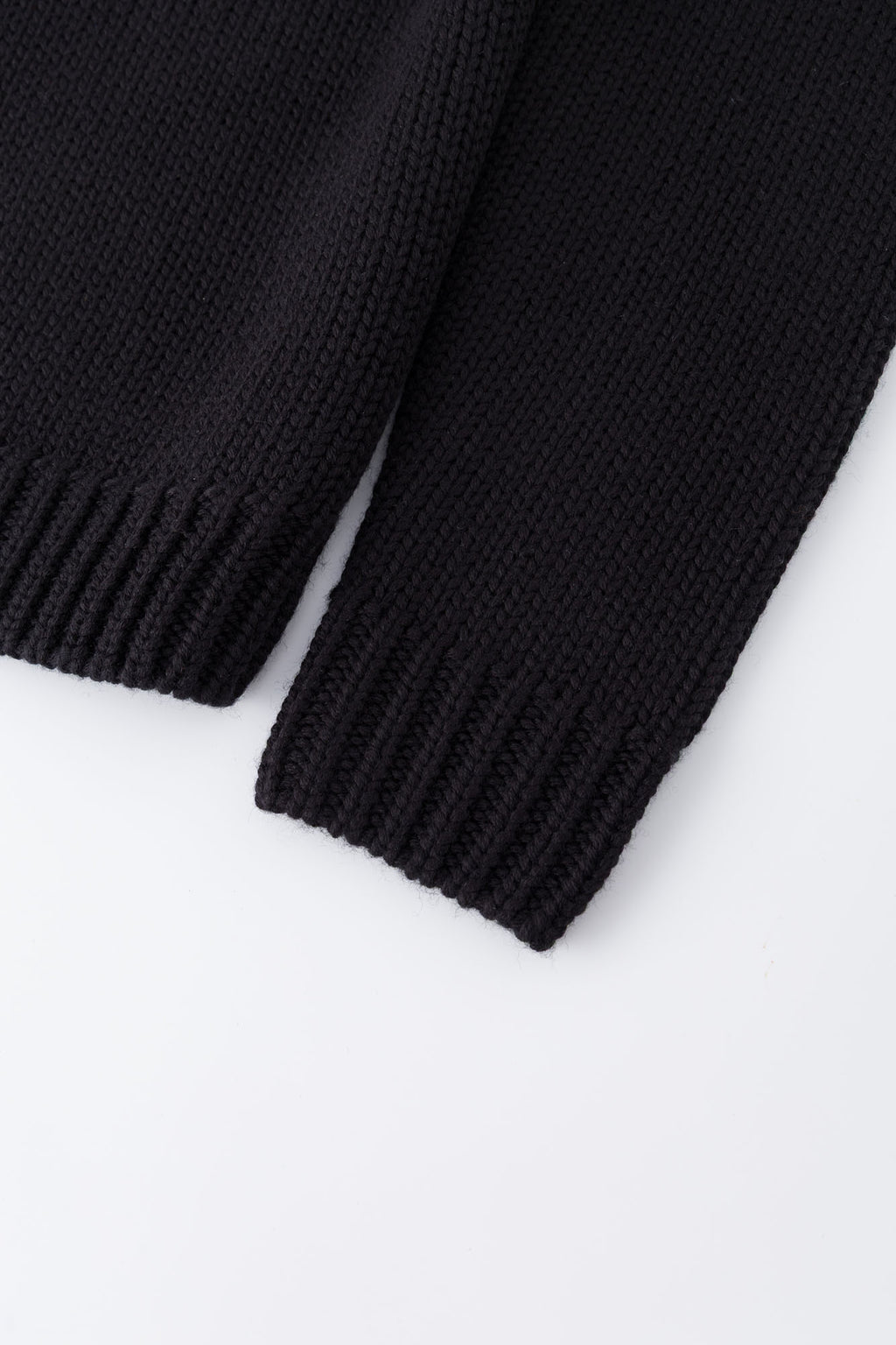 Black knit sweater designed to look like a shirt, with blue collar and attachable name tag and employee of the month pin
