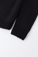 Black knit sweater designed to look like a shirt, with blue collar and attachable name tag and employee of the month pin