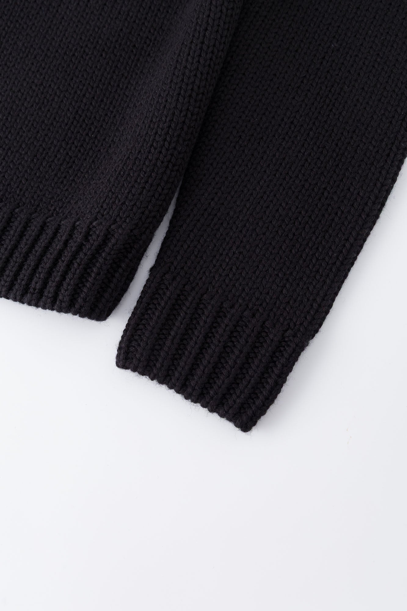 Black knit sweater designed to look like a shirt, with blue collar and attachable name tag and employee of the month pin