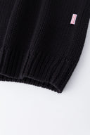 Black knit sweater designed to look like a shirt, with blue collar and attachable name tag and employee of the month pin