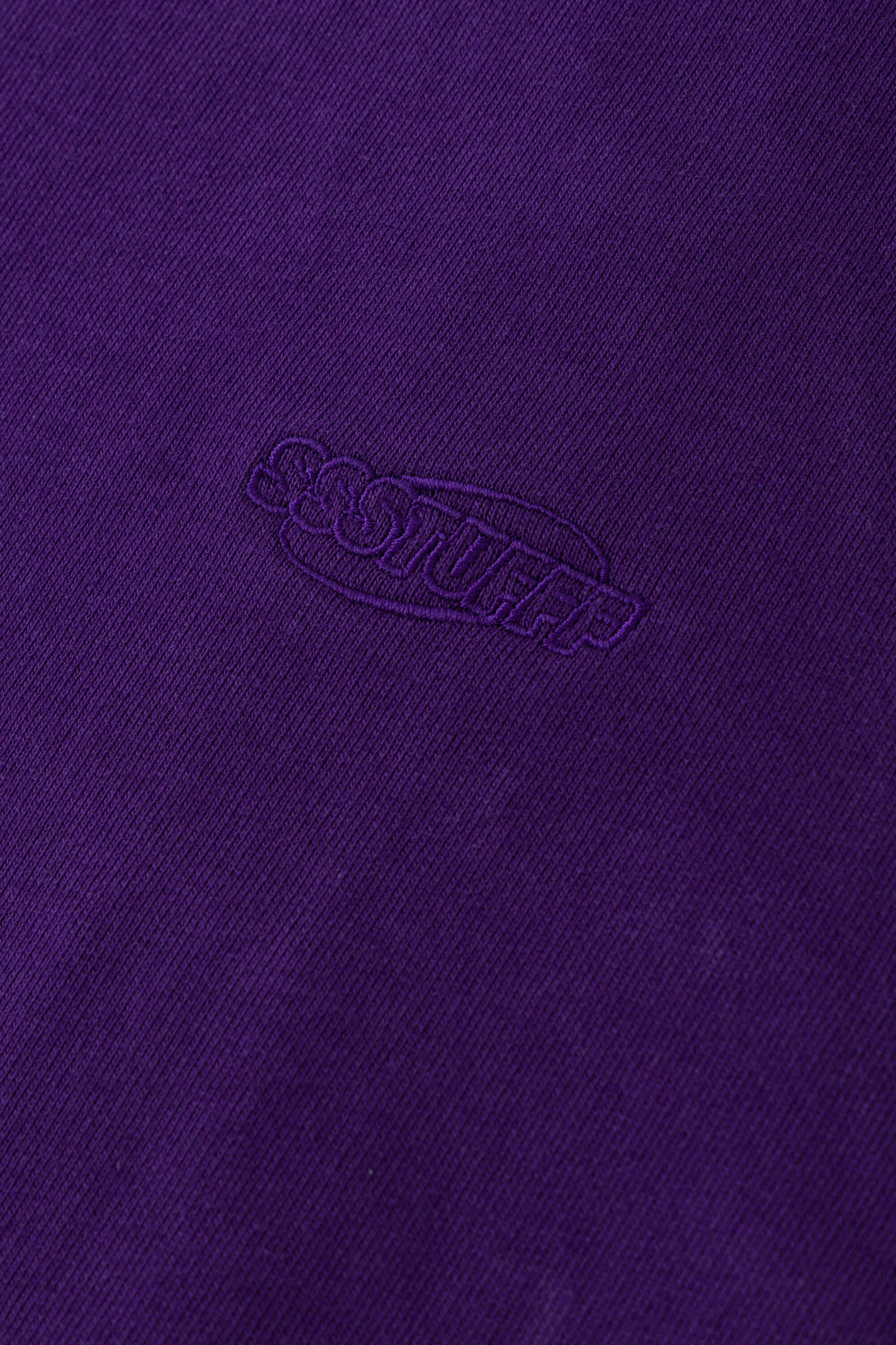 Purple zip-up hoodie with embroidered mini logo on the back