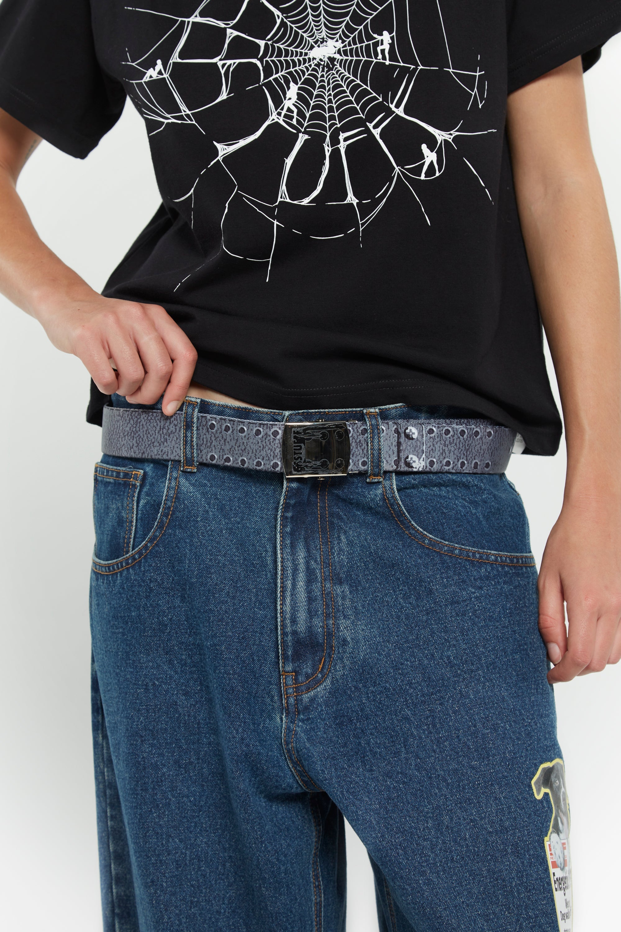 Canvas belt with printed rivets, metallic detailing, and SSSTUFFF engraved adjustable buckle