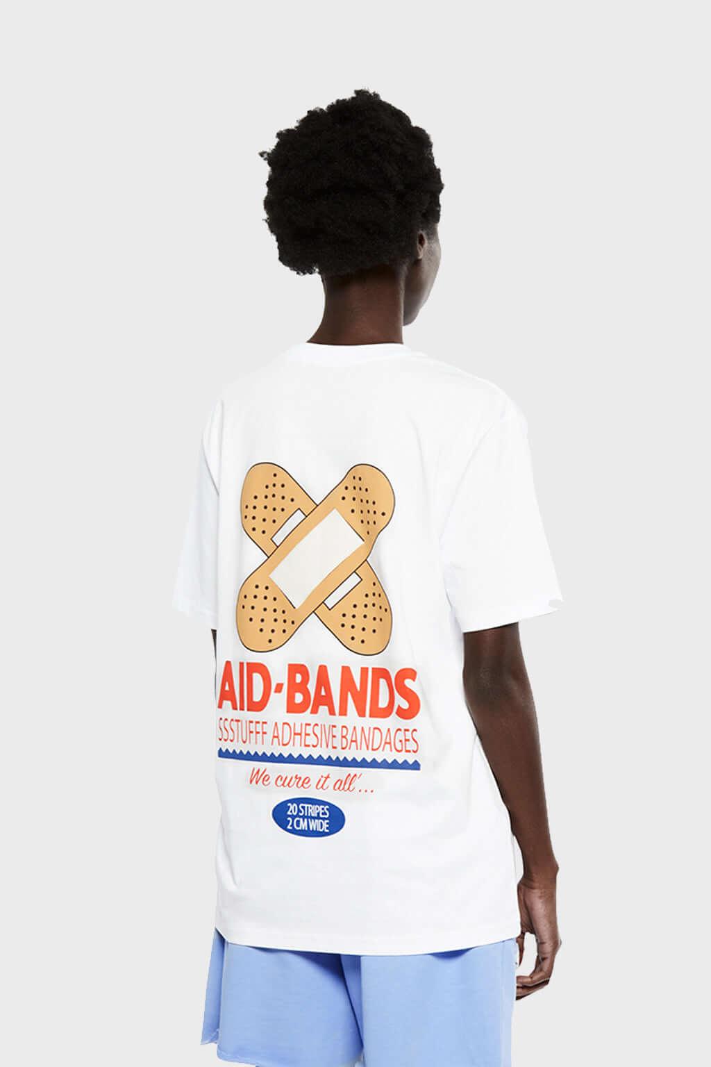 White t-shirt with bandaid graphic and text on a white background