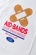White t-shirt with bandaid graphic and text on a white background