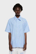 Blue short-sleeved button-up shirt with a pattern of stars and stripes on the chest area.