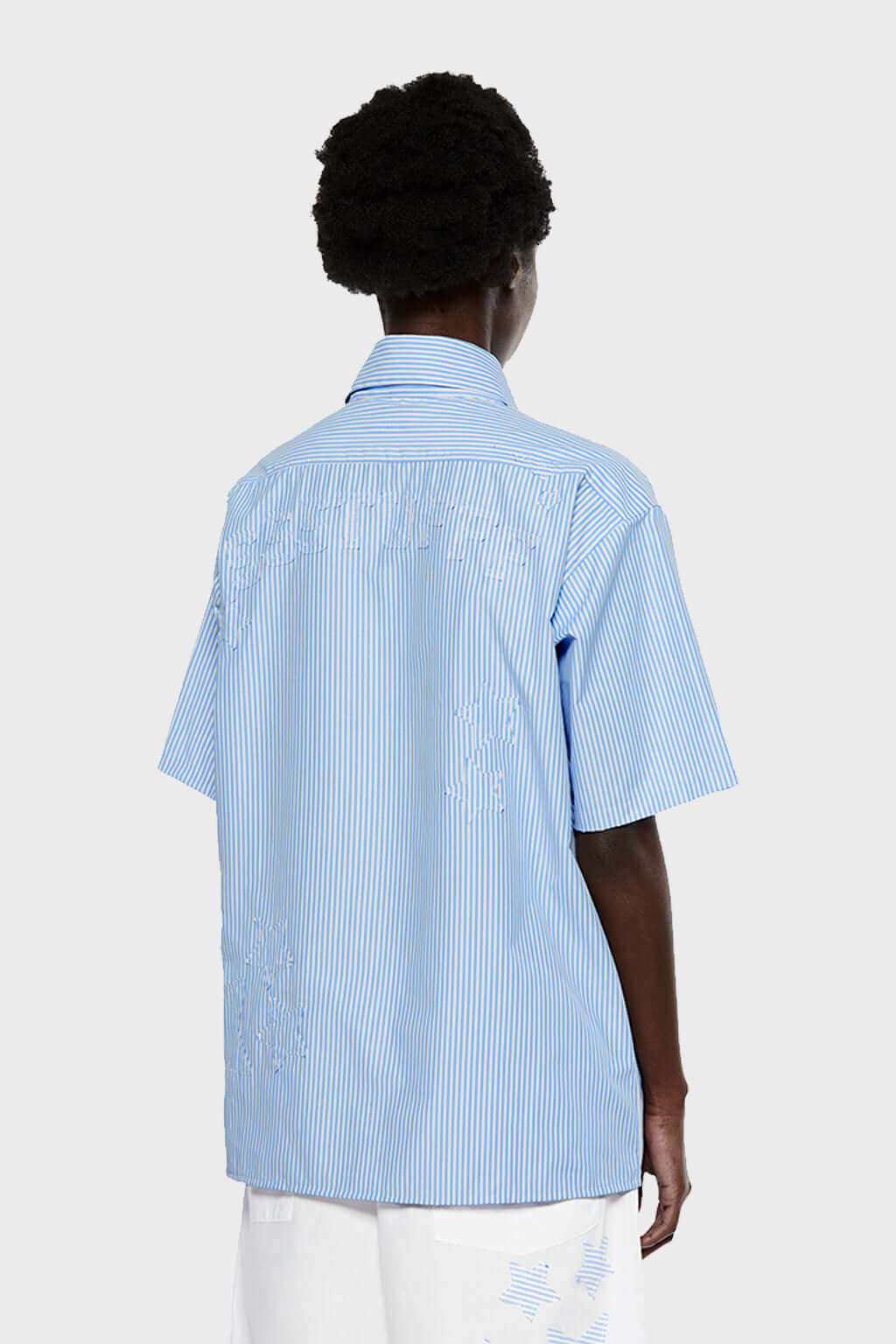 Blue short-sleeved button-up shirt with a pattern of stars and stripes on the chest area.