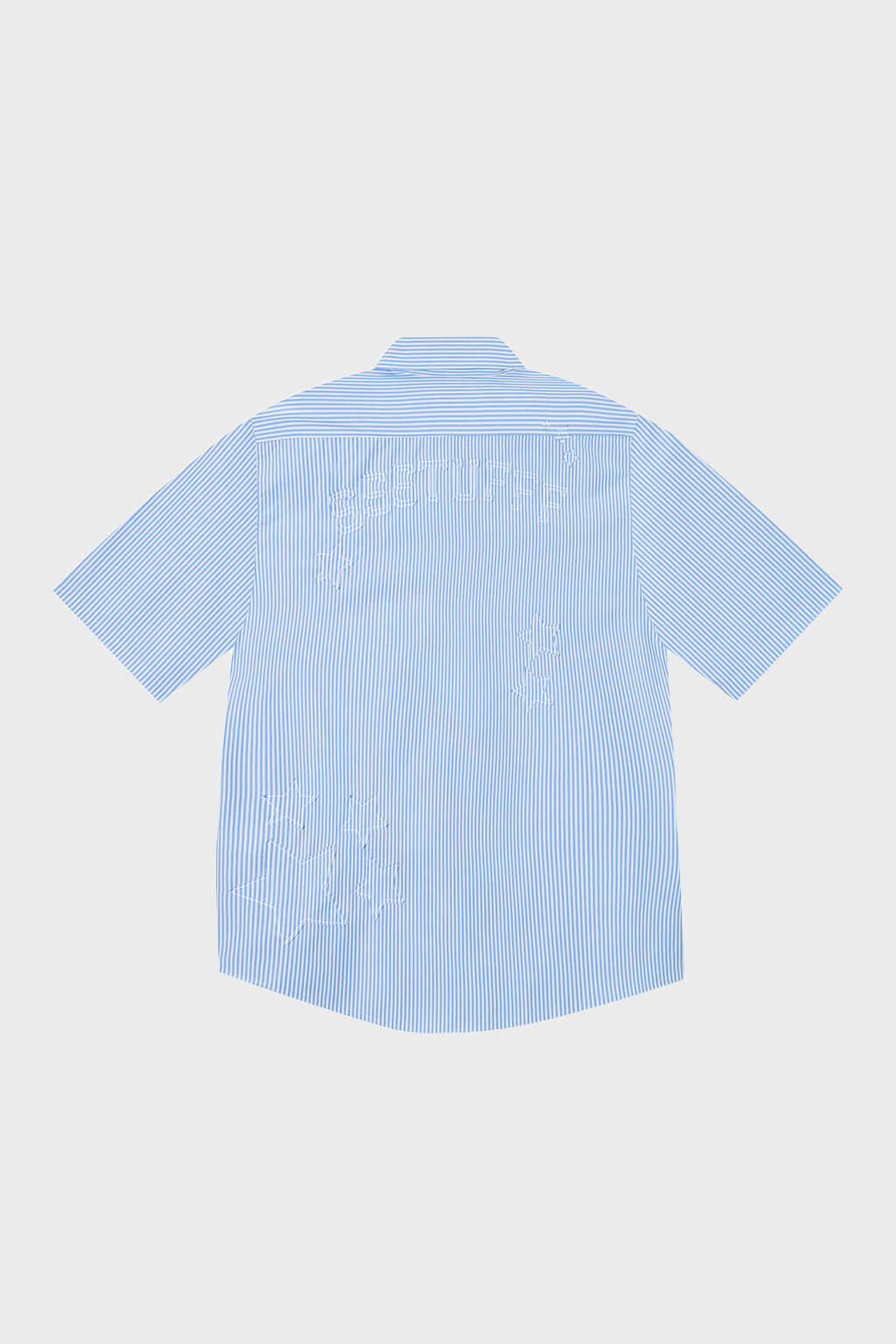 Blue short-sleeved button-up shirt with a pattern of stars and stripes on the chest area.