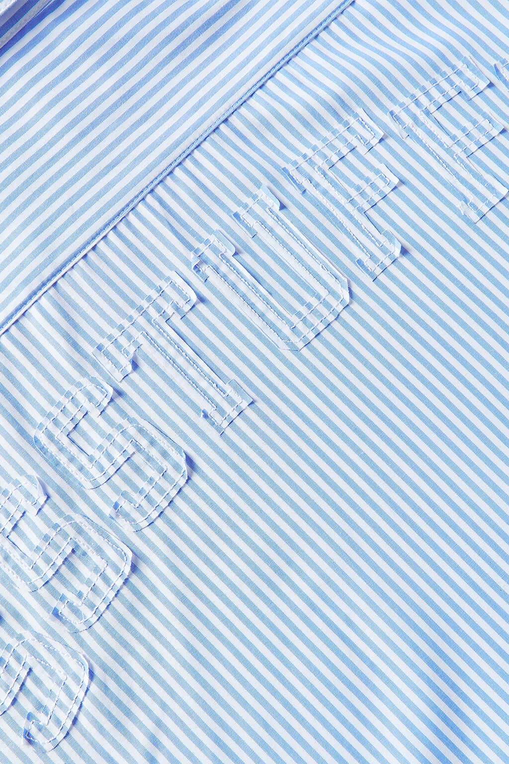 Blue short-sleeved button-up shirt with a pattern of stars and stripes on the chest area.