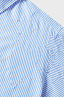 Blue short-sleeved button-up shirt with a pattern of stars and stripes on the chest area.