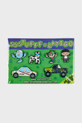 A pack of six metallic pins with a collaboration carton, featuring various designs including a blue creature, a white dog, two cartoon characters, and two vehicles.