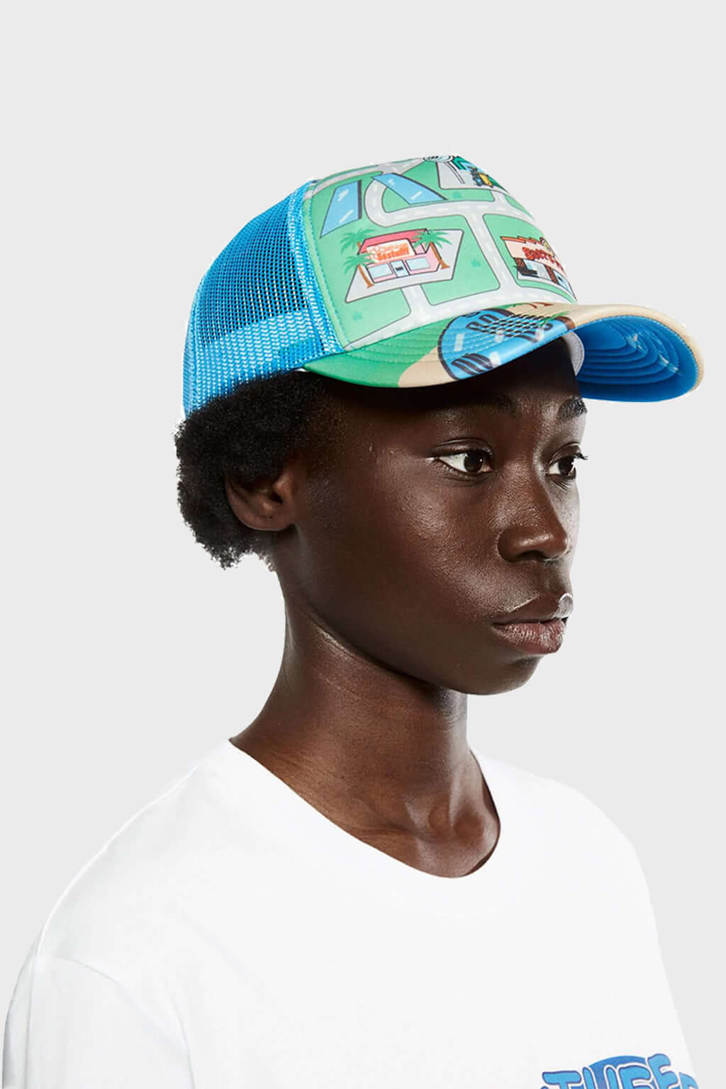 A trucker cap with a city map print featuring various buildings.