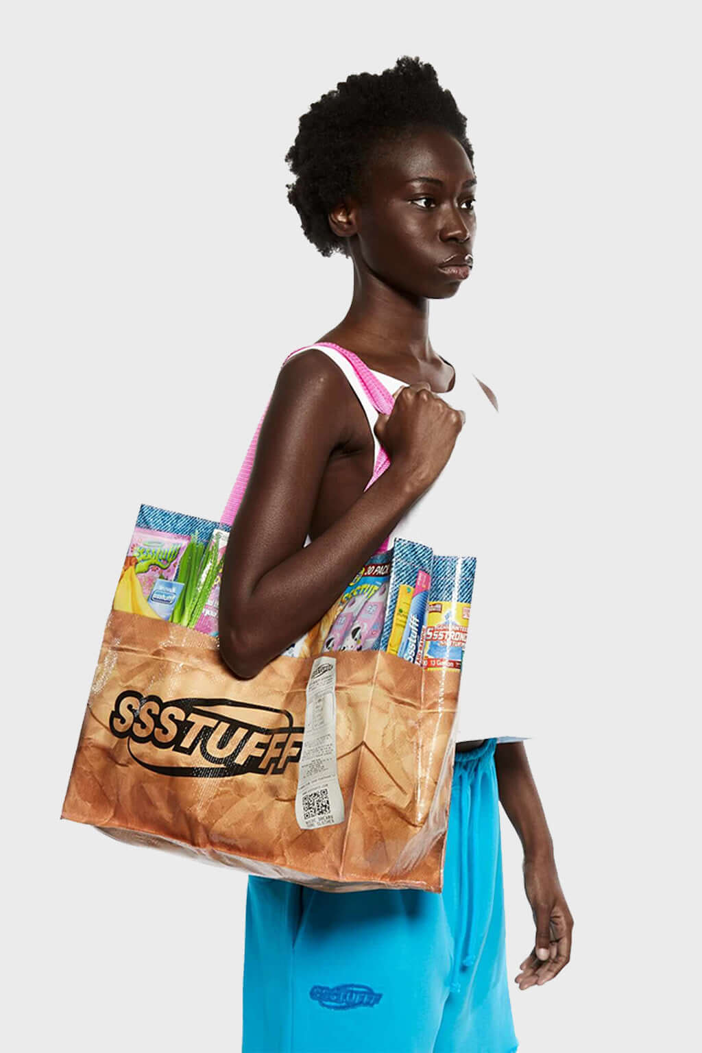 A multicolor grocery bag with 'SSSTUFF' printed on it and equipped with two strong cotton handles.