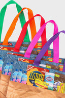 A multicolor grocery bag with 'SSSTUFF' printed on it and equipped with two strong cotton handles.