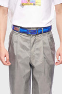 A printed PU leather belt with a slideable adjust and button release, featuring a denim emulated print.