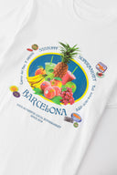 White t-shirt with various colorful fruits graphic, Barcelona text, and scented print that smells like sweet banana