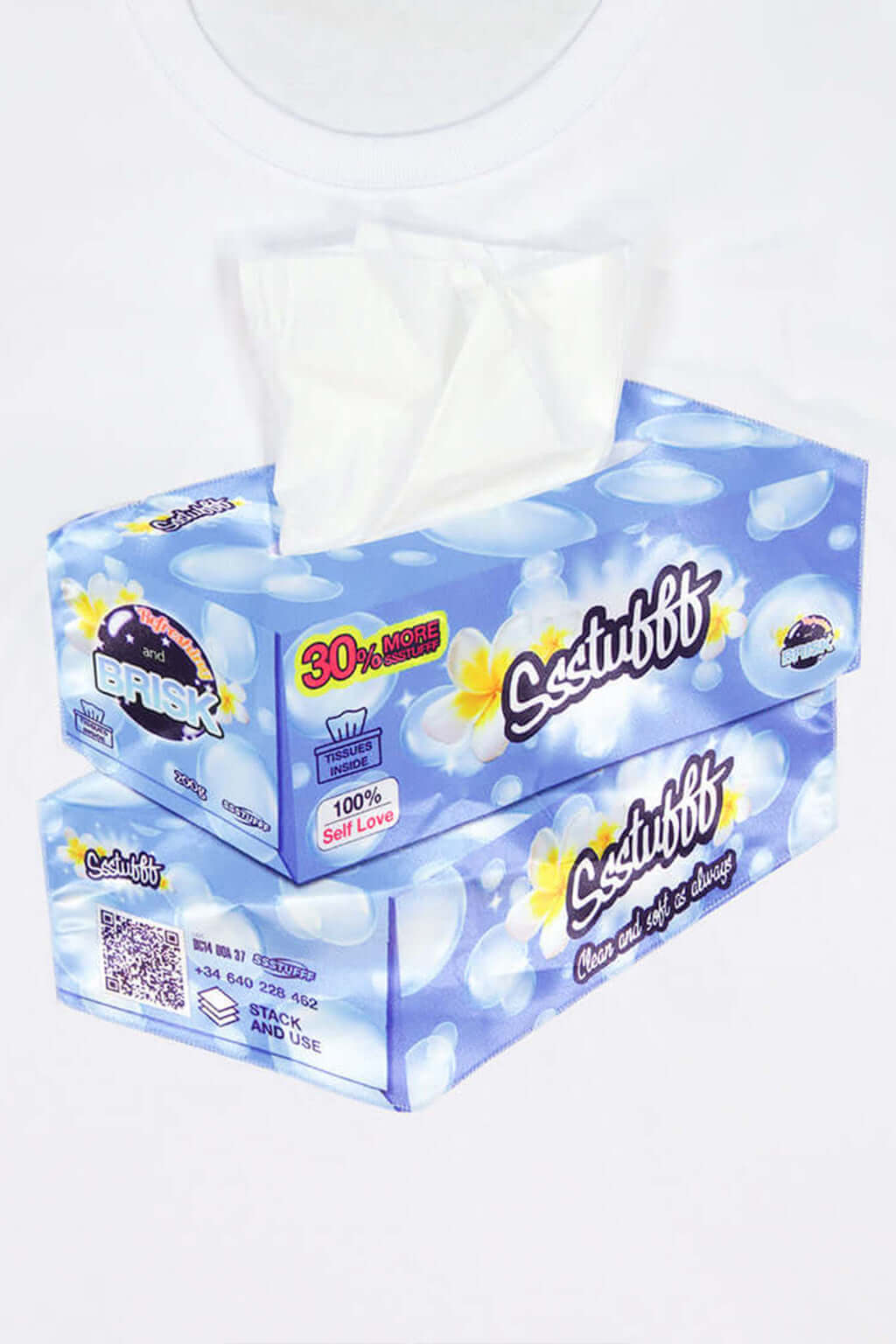 White or black t-shirt with embroidered tissue box patch on chest and functional tissue paper dispenser