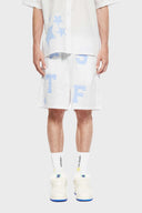 A pair of white shorts with blue striped stars and patchwork details.