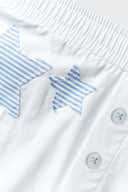 A pair of white shorts with blue striped stars and patchwork details.