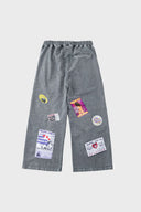 Oversized wide trousers with hand-sewn and applied vintage advertisement patches