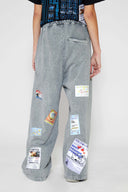 Oversized wide trousers with hand-sewn and applied vintage advertisement patches