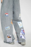 Oversized wide trousers with hand-sewn and applied vintage advertisement patches