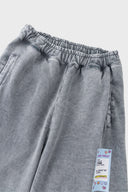 Oversized wide trousers with hand-sewn and applied vintage advertisement patches