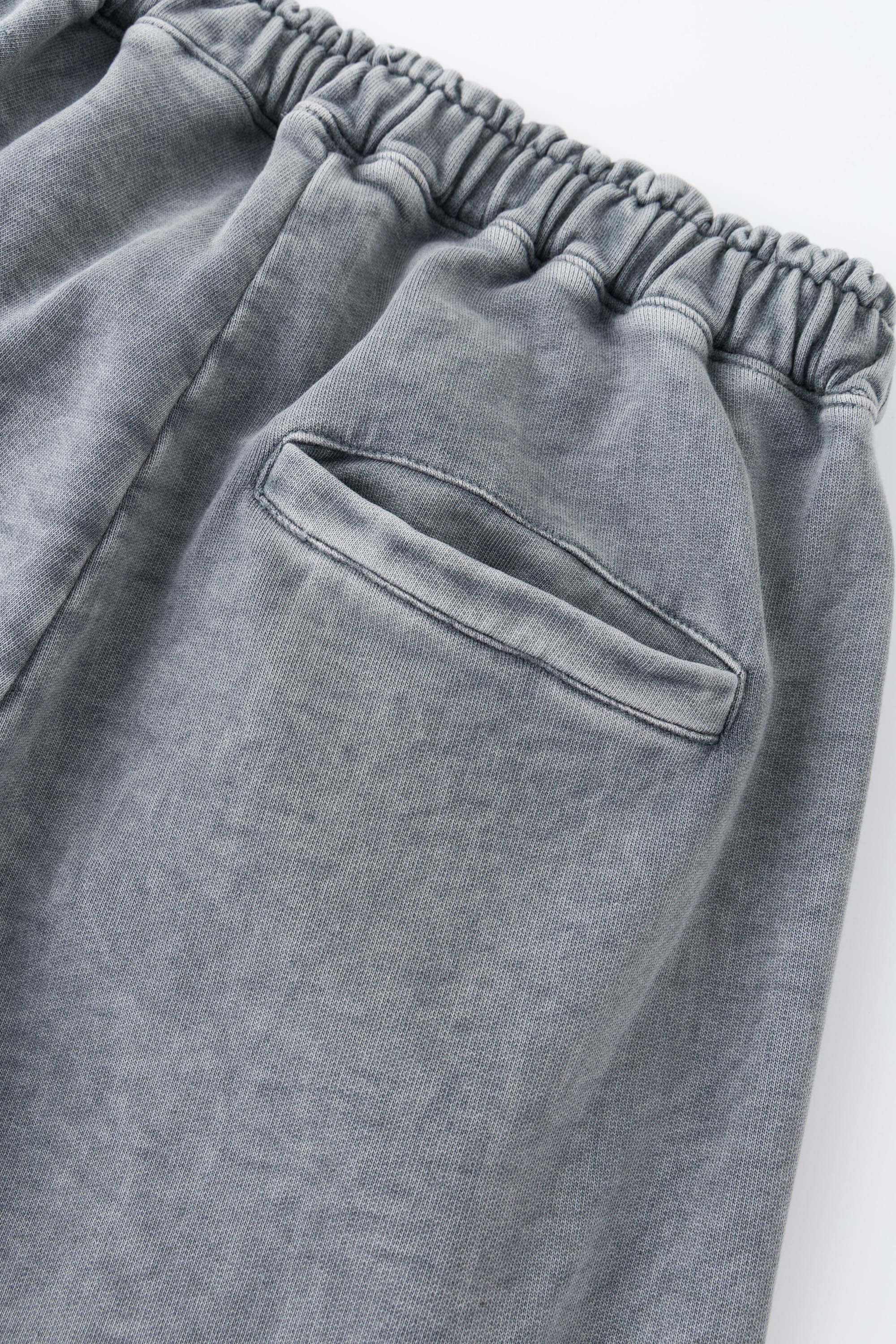 Oversized wide trousers with hand-sewn and applied vintage advertisement patches