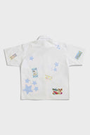 White shirt with jacquard, vinyl, and sublimated birthday postcard graphics inspired by greeting cards