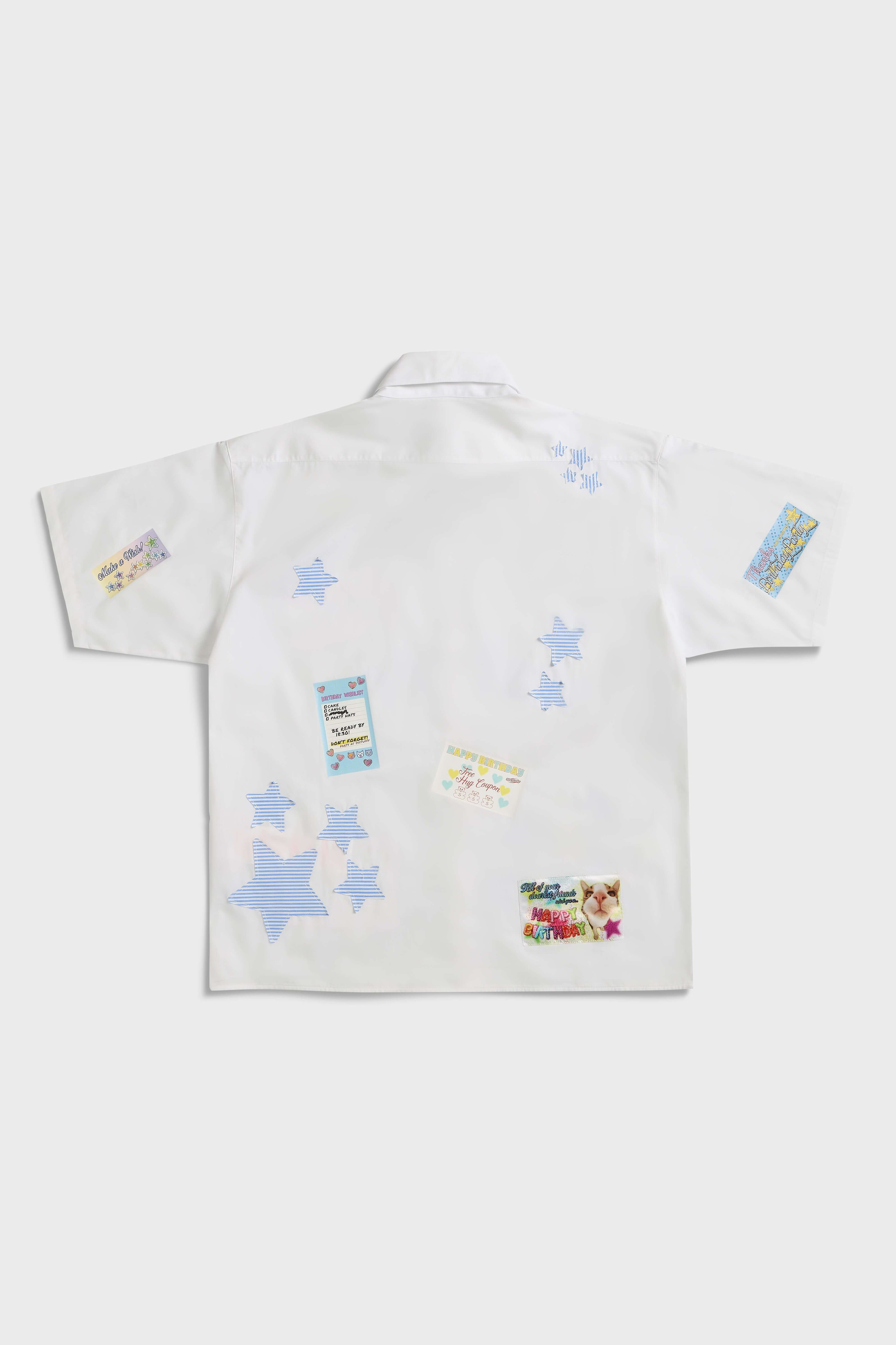 White shirt with jacquard, vinyl, and sublimated birthday postcard graphics inspired by greeting cards