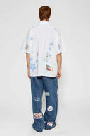 White shirt with jacquard, vinyl, and sublimated birthday postcard graphics inspired by greeting cards