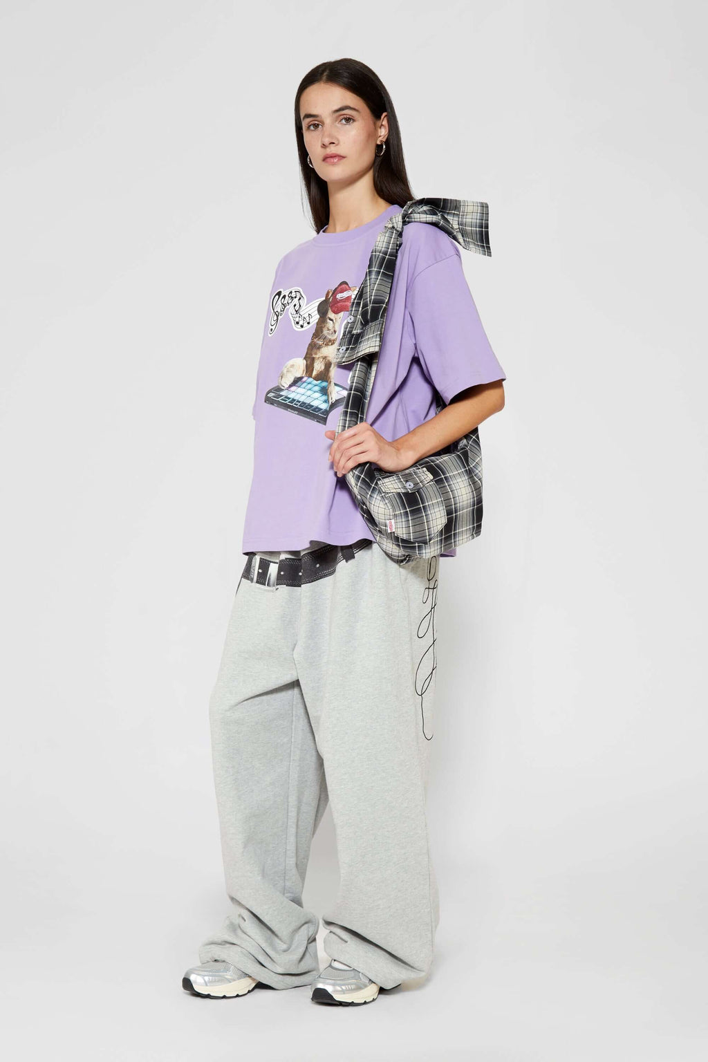Black and white checked croissant-shaped mini bag with shirt texture and adjustable sleeve handles for shoulder or crossbody wear